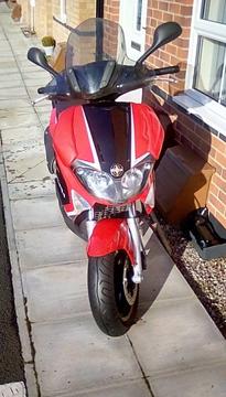 Registered as 125 but bored out to 185 has heated grips and a sports exhaust also with it
